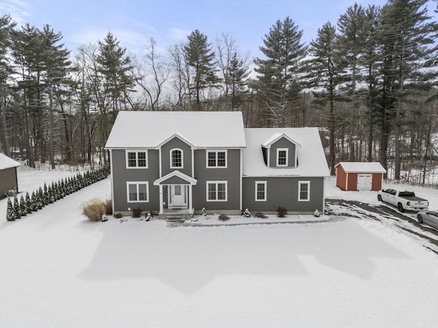 view of front of home featuring a storage shed