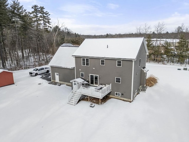 snow covered property with a wooden deck