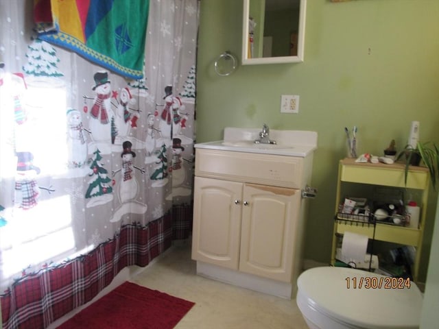 bathroom with toilet, walk in shower, and vanity