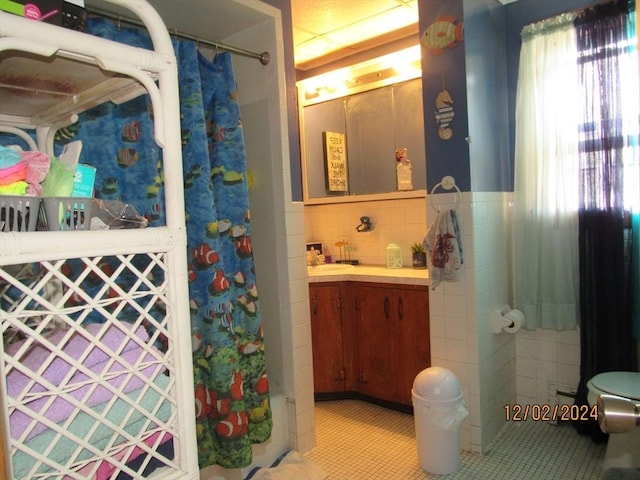 bathroom featuring tile patterned flooring, tasteful backsplash, vanity, and curtained shower