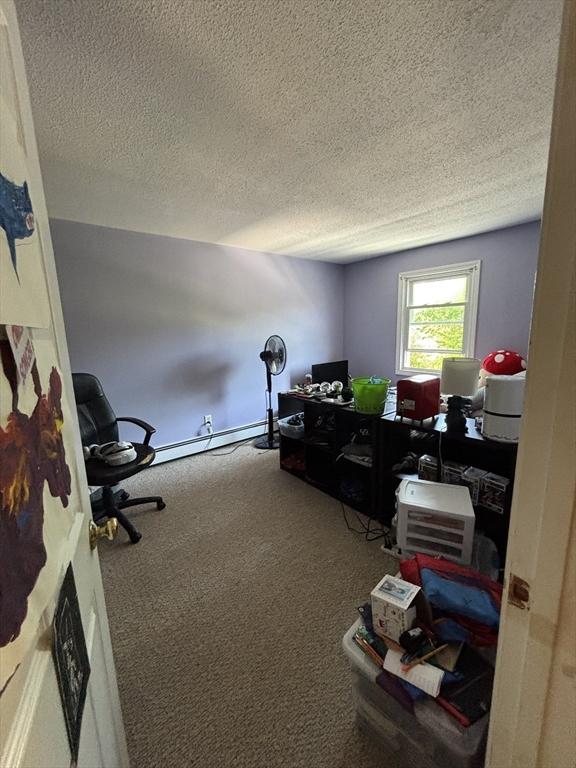 115 Redemption Rock Trl, Sterling, MA 01564 - carpeted home office with a textured ceiling and a baseboard heating unit