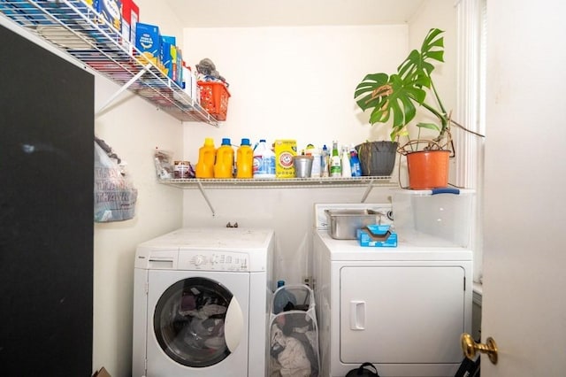 clothes washing area with separate washer and dryer