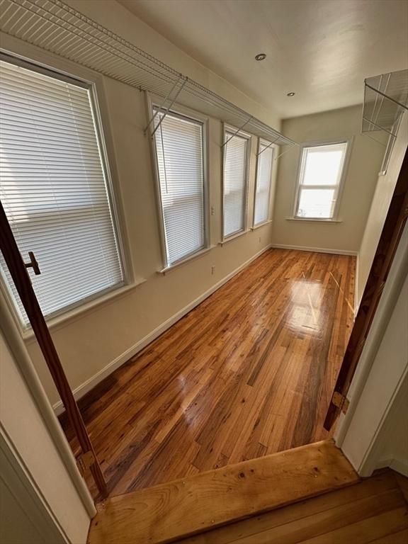 empty room featuring light wood-style flooring and baseboards