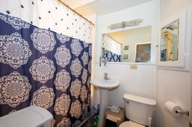 bathroom with toilet and curtained shower