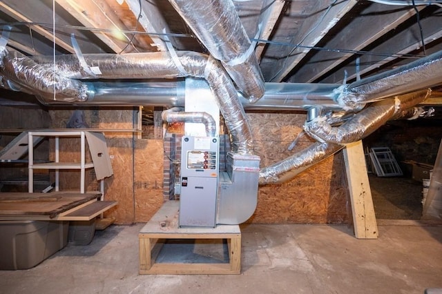 unfinished basement featuring heating unit