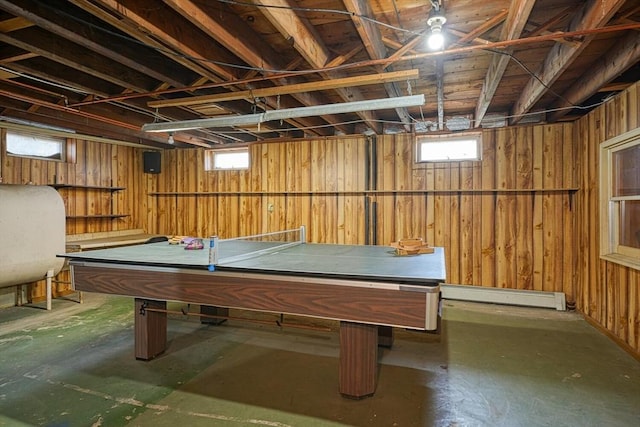 recreation room with a baseboard heating unit, heating fuel, wooden walls, and pool table