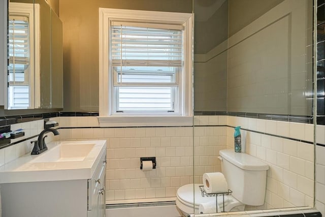 bathroom featuring tile walls, vanity, and toilet