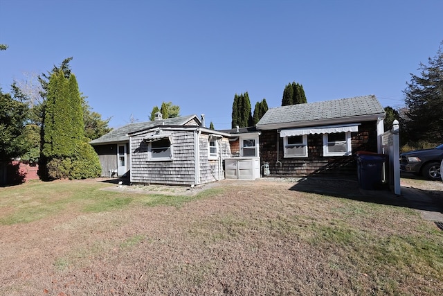 back of property featuring a yard