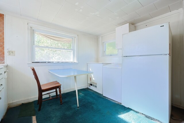 dining room with washer / clothes dryer and dark colored carpet