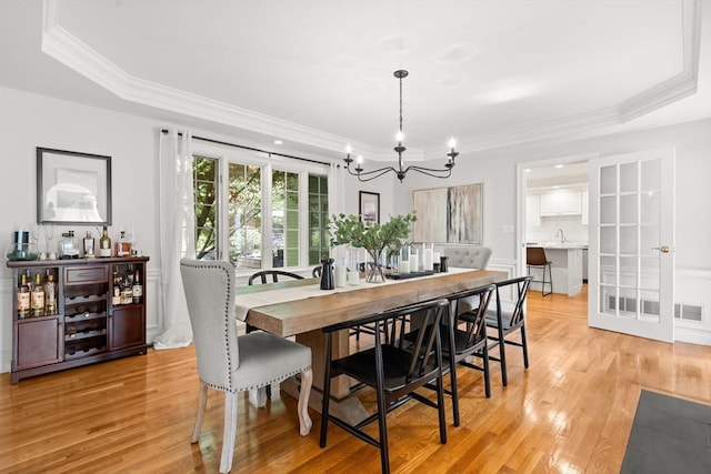 12 Scotland Dr, Andover, MA 01810 - dining room featuring a chandelier, a raised ceiling, light wood-style floors, and crown molding