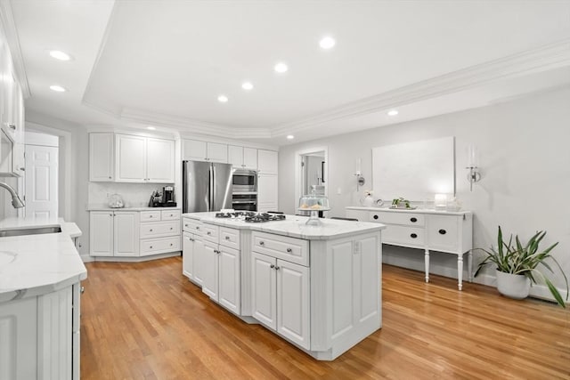 12 Scotland Dr, Andover, MA 01810 - kitchen featuring stainless steel appliances, a sink, white cabinets, recessed lighting, and a kitchen island