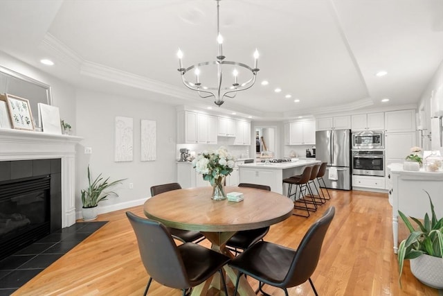12 Scotland Dr, Andover, MA 01810 - dining area featuring a raised ceiling, recessed lighting, a chandelier, crown molding, and light wood-style floors