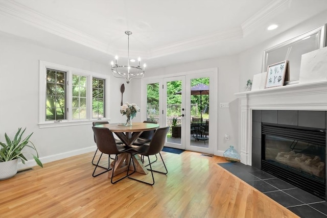 12 Scotland Dr, Andover, MA 01810 - dining area with a tray ceiling, light wood finished floors, plenty of natural light, crown molding, and a chandelier