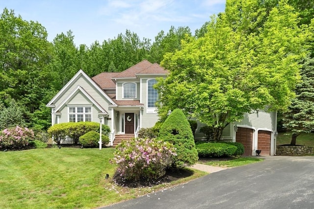 12 Scotland Dr, Andover, MA 01810 - view of front facade featuring a front lawn, asphalt driveway, and a garage