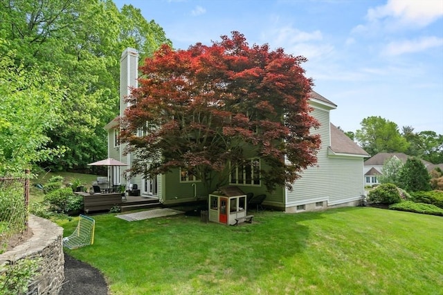 12 Scotland Dr, Andover, MA 01810 - view of side of property with a wooden deck, a yard, and a chimney