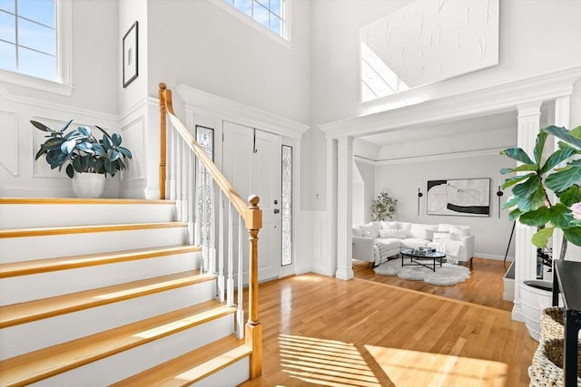 12 Scotland Dr, Andover, MA 01810 - foyer entrance with a high ceiling, stairs, wood finished floors, a decorative wall, and wainscoting