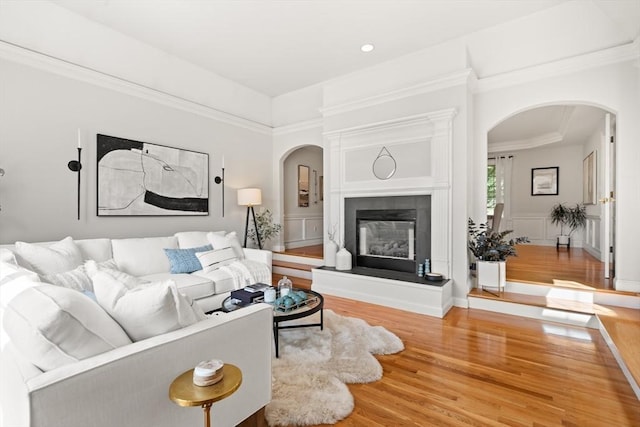 12 Scotland Dr, Andover, MA 01810 - living area featuring arched walkways, wood finished floors, a fireplace, ornamental molding, and recessed lighting