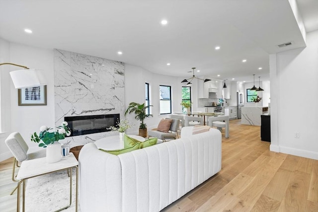 42 Bower St Unit 2, Medford, MA 02155 - living room featuring recessed lighting, light wood-style flooring, a fireplace, and baseboards