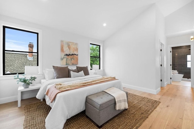 42 Bower St Unit 2, Medford, MA 02155 - bedroom with baseboards, light wood-style floors, connected bathroom, high vaulted ceiling, and recessed lighting