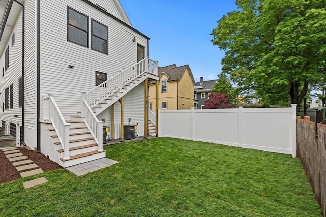 42 Bower St Unit 2, Medford, MA 02155 - rear view of property featuring stairway and central AC