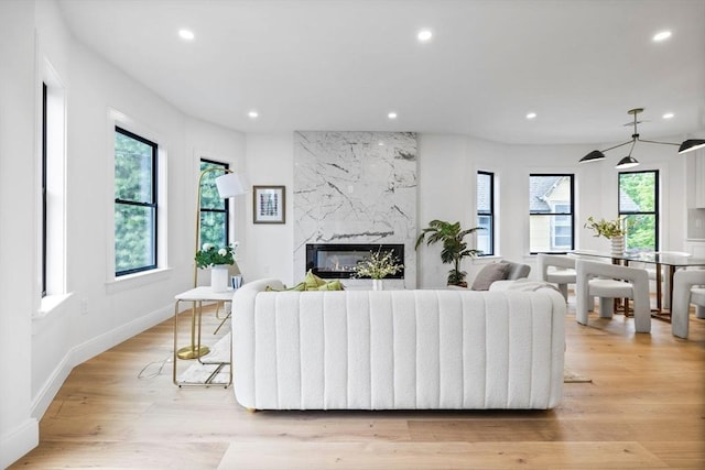 42 Bower St Unit 2, Medford, MA 02155 - living area featuring plenty of natural light, recessed lighting, a fireplace, light wood finished floors, and baseboards