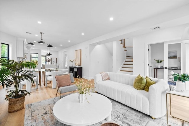 42 Bower St Unit 2, Medford, MA 02155 - living room with recessed lighting, light wood-style floors, and stairs