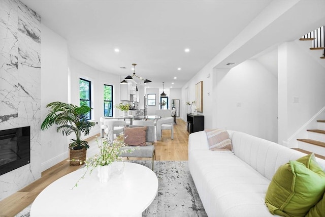 42 Bower St Unit 2, Medford, MA 02155 - living room featuring stairs, recessed lighting, a premium fireplace, and light wood finished floors