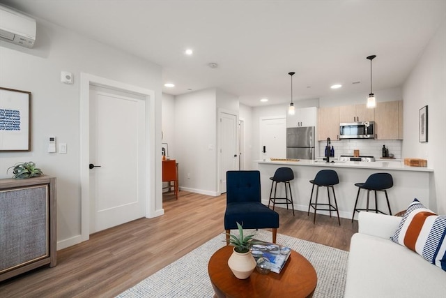 10 Somerset Unit 403, Winthrop, MA 02152 - living room featuring a wall mounted air conditioner, light wood-style floors, recessed lighting, and baseboards
