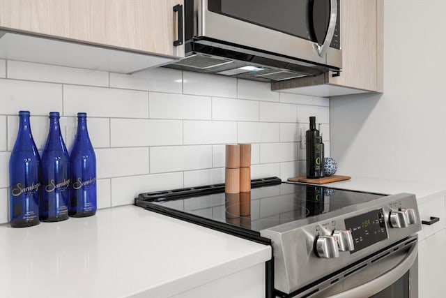 10 Somerset Unit 403, Winthrop, MA 02152 - kitchen featuring stainless steel appliances, backsplash, and light countertops