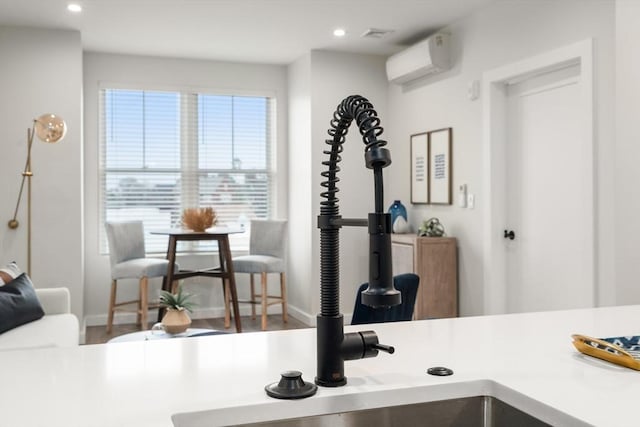 10 Somerset Unit 403, Winthrop, MA 02152 - kitchen featuring a wall mounted AC, recessed lighting, baseboards, a sink, and wood finished floors