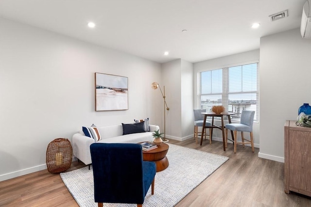 10 Somerset Unit 403, Winthrop, MA 02152 - living room with light wood finished floors, baseboards, recessed lighting, and an AC wall unit