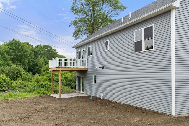 4 Bronson St, Fall River, MA 02721 - rear view of property with a wooden deck, roof with shingles, and dirt driveway