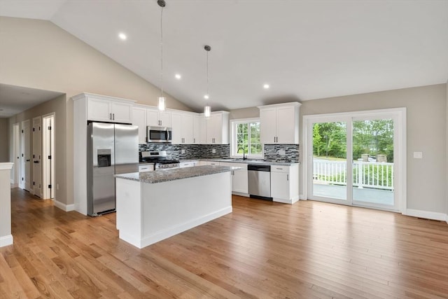 4 Bronson St, Fall River, MA 02721 - kitchen featuring appliances with stainless steel finishes, a kitchen island, tasteful backsplash, light wood finished floors, and recessed lighting