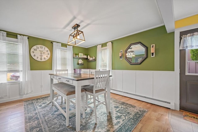 217 Hathaway Commons Rd, Fall River, MA 02720 - dining area featuring a baseboard radiator, healthy amount of natural light, a wainscoted wall, wood finished floors, and ornamental molding