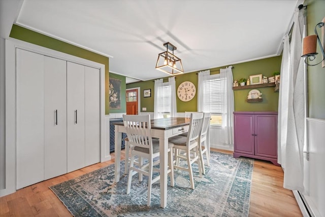 217 Hathaway Commons Rd, Fall River, MA 02720 - dining room with a baseboard radiator, light wood finished floors, and a wainscoted wall