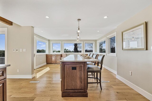 17 Wagon Wheel Rd, Winchester, MA 01890 - kitchen with a kitchen breakfast bar, light countertops, baseboards, a kitchen island, and recessed lighting