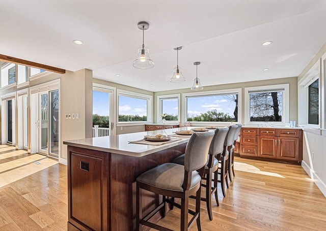 17 Wagon Wheel Rd, Winchester, MA 01890 - kitchen with light countertops, light wood-type flooring, pendant lighting, brown cabinets, and recessed lighting