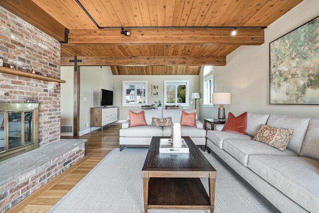 17 Wagon Wheel Rd, Winchester, MA 01890 - living area with wooden ceiling, wood finished floors, a barn door, rail lighting, and baseboards