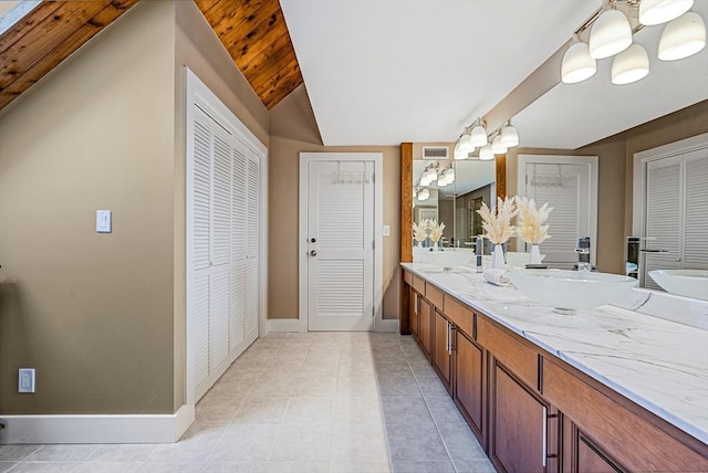 17 Wagon Wheel Rd, Winchester, MA 01890 - full bath featuring a closet, double vanity, baseboards, and tile patterned flooring