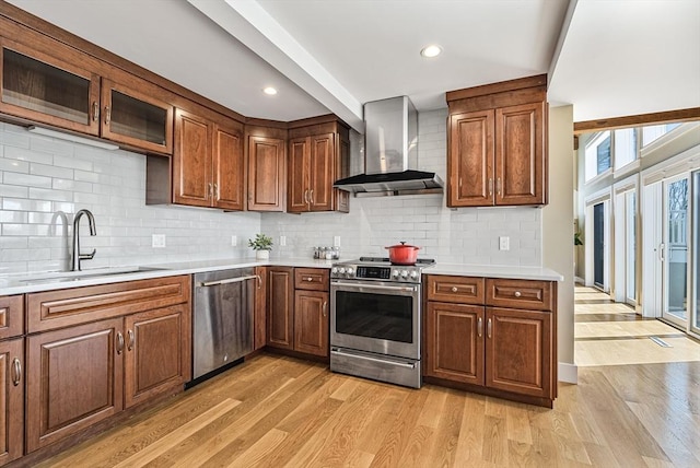 17 Wagon Wheel Rd, Winchester, MA 01890 - kitchen with wall chimney exhaust hood, stainless steel appliances, a sink, light wood-type flooring, and recessed lighting