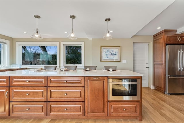 17 Wagon Wheel Rd, Winchester, MA 01890 - kitchen with stainless steel appliances, light countertops, light wood-style floors, pendant lighting, and recessed lighting