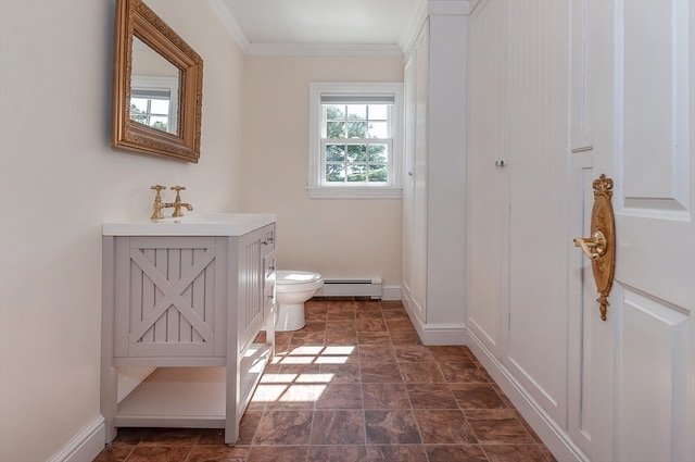 bathroom featuring a baseboard heating unit, toilet, crown molding, and vanity