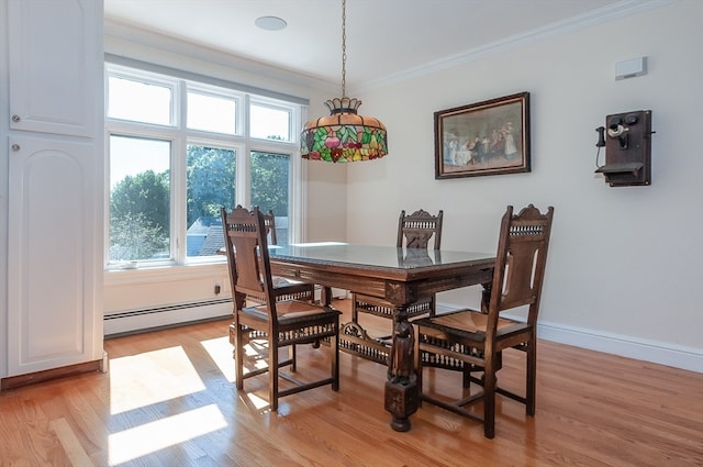 dining room featuring light hardwood / wood-style flooring, baseboard heating, and ornamental molding