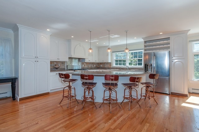 kitchen with a center island, white cabinetry, plenty of natural light, and stainless steel appliances