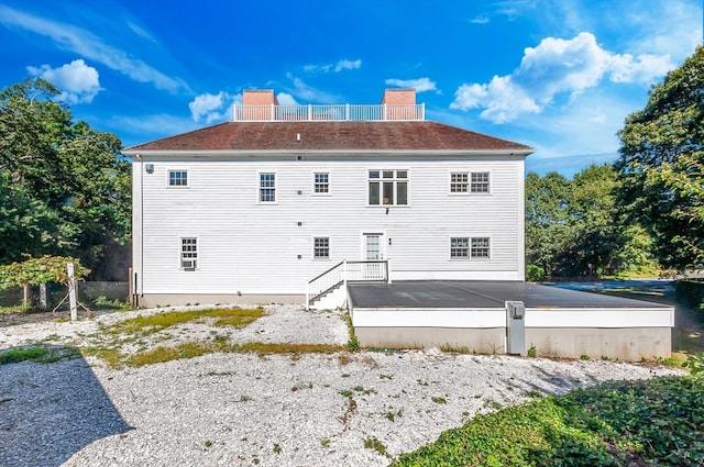 rear view of house featuring a deck