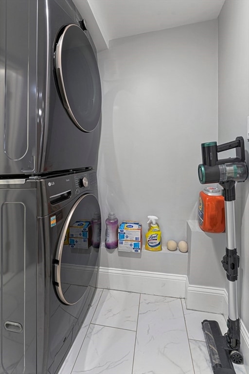 laundry area with stacked washer / dryer