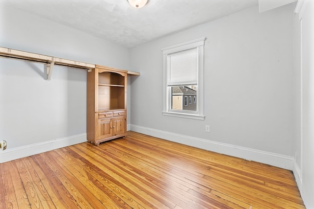 unfurnished bedroom with hardwood / wood-style flooring