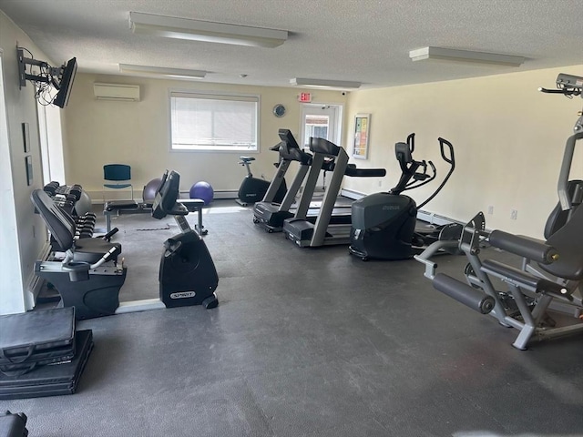 gym featuring a textured ceiling, an AC wall unit, and baseboard heating