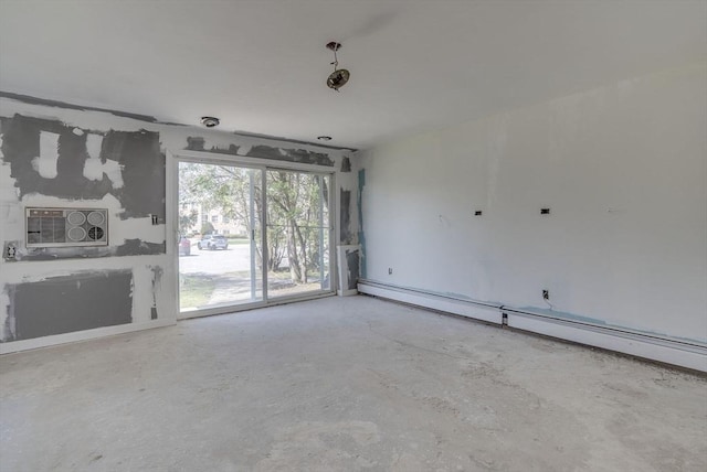 unfurnished living room featuring baseboard heating and concrete floors