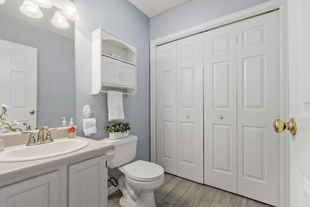 4 Quail Run Dr, Methuen, MA 01844 - bathroom featuring a closet, toilet, wood finished floors, and vanity